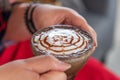 Hand women with cappuccino coffee in a cup blurred background Royalty Free Stock Photo