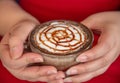 Hand women with cappuccino coffee in a cup blurred background Royalty Free Stock Photo