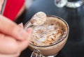 Hand women with cappuccino coffee in spoon Royalty Free Stock Photo