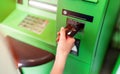 Hand of a women with a credit card, using an ATM. Woman using an atm machine with his credit card.