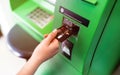 Hand of a women with a credit card, using an ATM. Woman using an atm machine with his credit card.