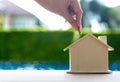 Hand women put the coin in the piggy bank house for sale house Royalty Free Stock Photo