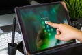 Hand of women tying tablet computer with password login on scree Royalty Free Stock Photo