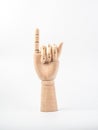 Hand of wood doll make fingers little finger to reconcile on white bakground