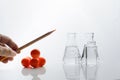 Hand with wood pencil and science glass flask and red molecular structure in chemistry education laboratory background