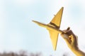 The hand with a wooden airplane on the background of the sunset. Military aircraft.