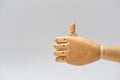 Hand of wooden doll with thumb up gesture isolated on grey Royalty Free Stock Photo
