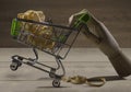 Wooden hand with shopping cart of sawdust.