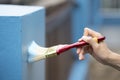 Hand worker holding brush painting blue on the wall house, diy and repair concept Royalty Free Stock Photo