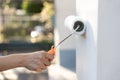 hand worker holding brush painting roller white on the wall house, diy and repair concept Royalty Free Stock Photo