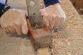 Hand of worker planing a plank of wood using a hand planer Royalty Free Stock Photo