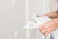 Hand of worker with plaster and trowel to gypsum board Royalty Free Stock Photo