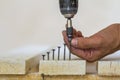 Hand of a worker screws a in a wooden board with a cordles Royalty Free Stock Photo