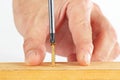 Hand of the worker screws in a wooden block with screwdriver Royalty Free Stock Photo