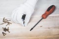 Hand of the worker screws in a wooden block with a screwdriver Royalty Free Stock Photo