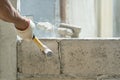 Hand of worker using hammer smashing and demolish on brick wall at construction site Royalty Free Stock Photo