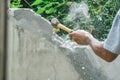 Hand of worker using hammer smashing and demolish on brick wall at construction site Royalty Free Stock Photo