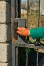 A hand in a working glove opens a door Royalty Free Stock Photo