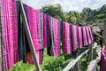 Hand woven clothes hang on wooden walkways in rice field at Sila Laeng, Pua District, Nan Royalty Free Stock Photo