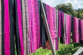 Hand woven clothes hang on wooden walkways in rice field at Sila Laeng, Pua District, Nan Royalty Free Stock Photo