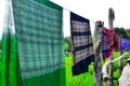 Hand woven clothes hang on wooden walkways in rice field at Sila Laeng, Pua District, Nan Royalty Free Stock Photo