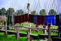 Hand woven clothes hang on wooden walkways in rice field at Sila Laeng, Pua District, Nan Royalty Free Stock Photo