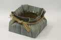 Hand woven pouch wrapped around a glass bowl