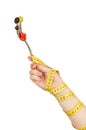 Hand wrapped with measuring tape holding a fork with berries