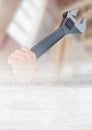 Hand with wrench on building site with transition effect Royalty Free Stock Photo