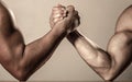 Muscular men measuring forces, arms. Hand wrestling, compete. Hands or arms of man. Muscular hand. Rivalry, closeup of