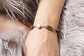 hand wrist wearing brass golden bracelet with mineral stone