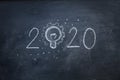 Hand write 2020 with light idea on blackboard