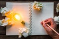 Hand write over Note book and light bulb