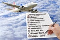 Hand write a Travel Checklist over a cloudy sky and airplane - c Royalty Free Stock Photo