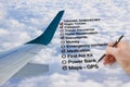 Hand write a Travel Checklist over a cloudy sky and airplane - c Royalty Free Stock Photo