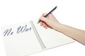 Hand writes the inscription `No war` with a pen in a notebook Royalty Free Stock Photo