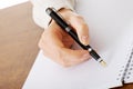 Hand writes with a pen in a notebook Royalty Free Stock Photo