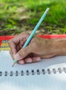 hand writes a pen in a notebook Royalty Free Stock Photo