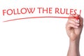 Hand writes words follow the rules with red marker Royalty Free Stock Photo