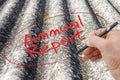 Hand writing `Annual Report` on a background image representing an asbestos roof