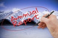 Hand writing Annual Report on a background image representing an asbestos roof - toned image