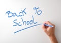 Hand writing back to school on white board Royalty Free Stock Photo