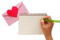 Hand writing on blank notebook with pink envelope and red heart paper origami Royalty Free Stock Photo