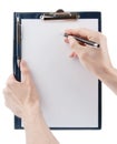 Hand writing on an empty document in a clipboard Royalty Free Stock Photo