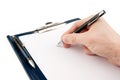 Hand writing on an empty document in a clipboard Royalty Free Stock Photo