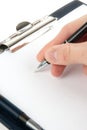 Hand writing on an empty document in a clipboard Royalty Free Stock Photo