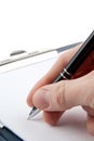 Hand writing on an empty document in a clipboard Royalty Free Stock Photo