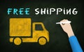 Hand Writing Free shipping Phrase and Drawing Shipping Truck Symbol on blackboard. Hand Written text on Chalkboard. Free Delivery