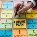Hand writing future plan on colorful sticky notes on wooden surface Royalty Free Stock Photo