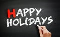 Hand writing Happy Holidays on blackboard, holiday concept background Royalty Free Stock Photo